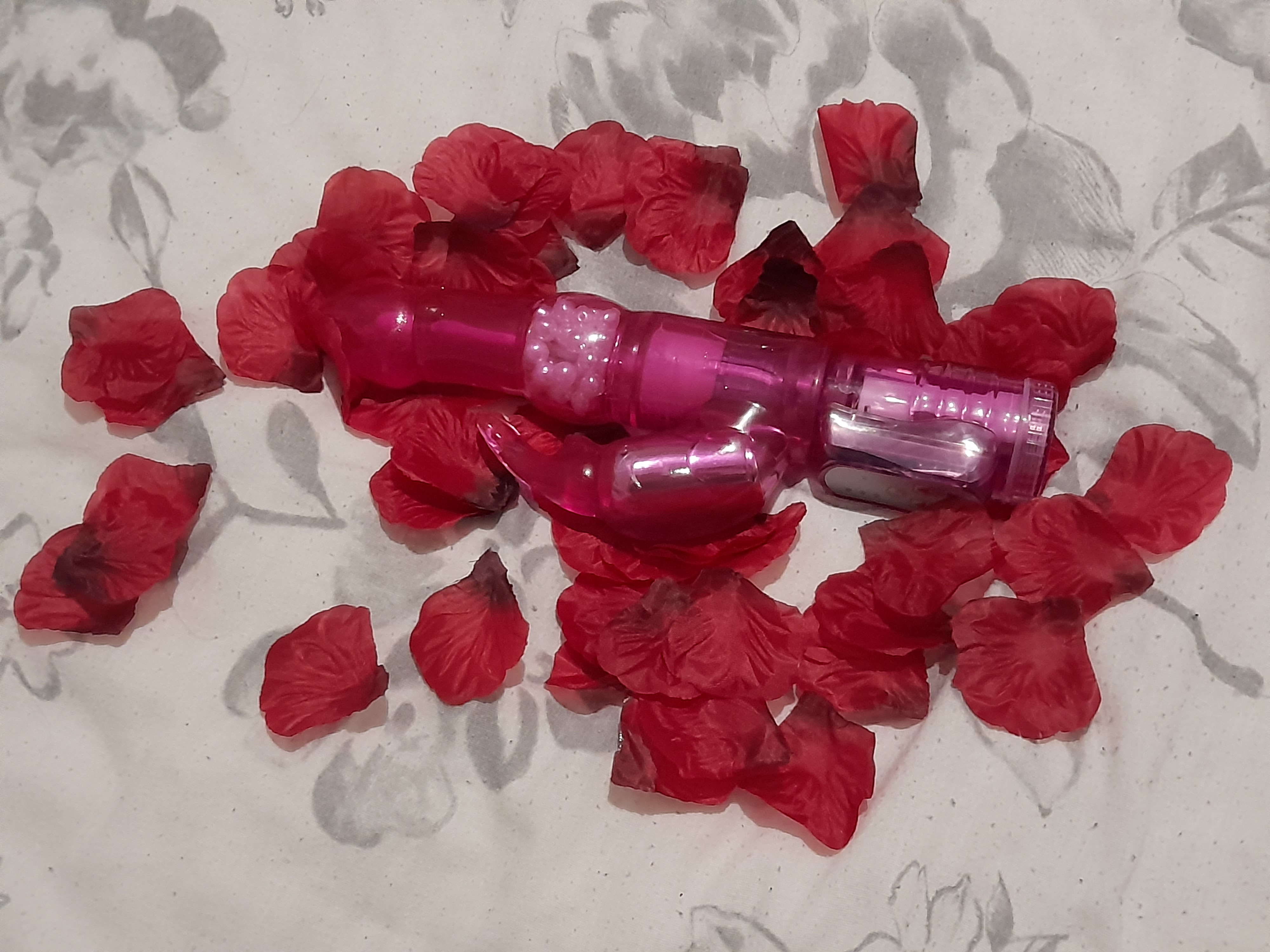 Lovehoney Jessica Rabbit 10 Function vibrator on a bed of red rose petals