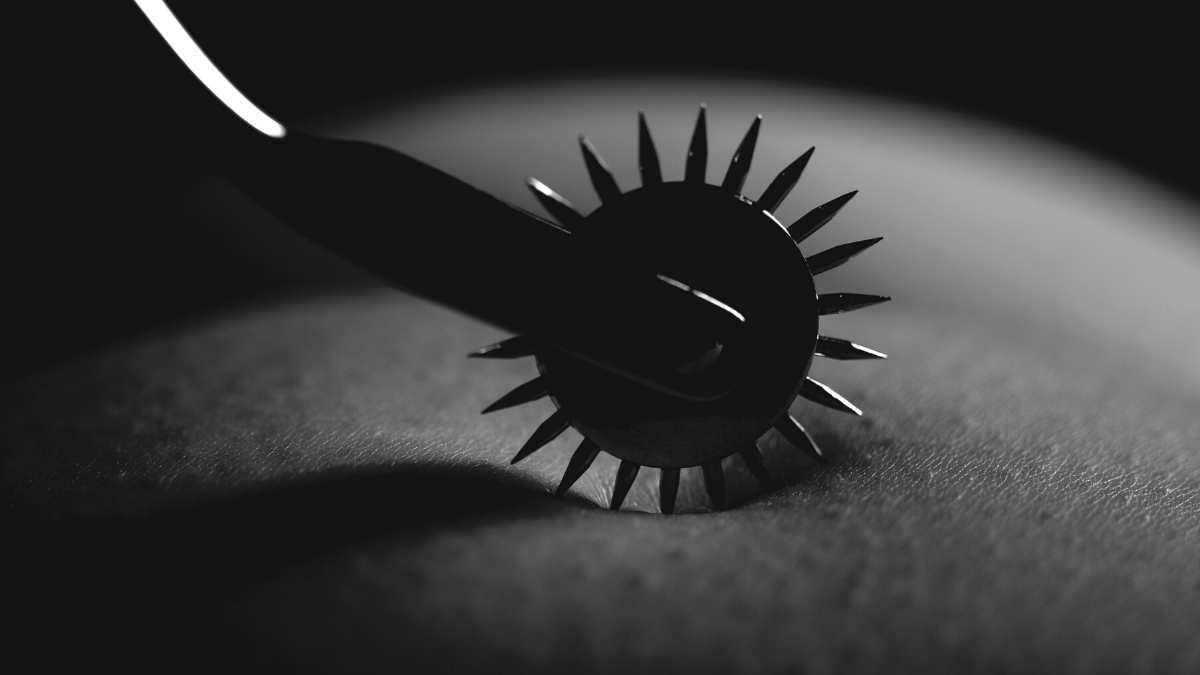 A black and white photo of a pinwheel on the skin for BDSM sensation play relationship kinky games