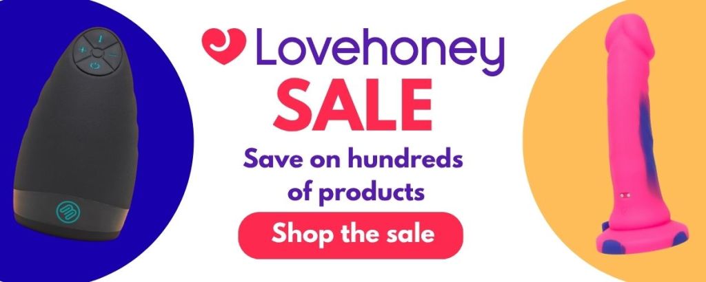 Banner promoting the Lovehoney Sale. The Lovehoney logo appears above the word "SALE" in large pink letters, with the text "Save on hundreds of products" and a pink "Shop the Sale" button. Product images are shown on either side of the banner against coloured circular backgrounds.