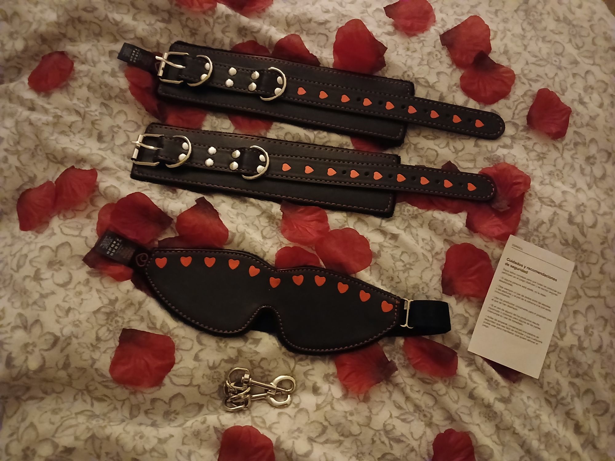Bondage Boutique Hearts Cuffs & Blindfold Set on a bed of red rose petals