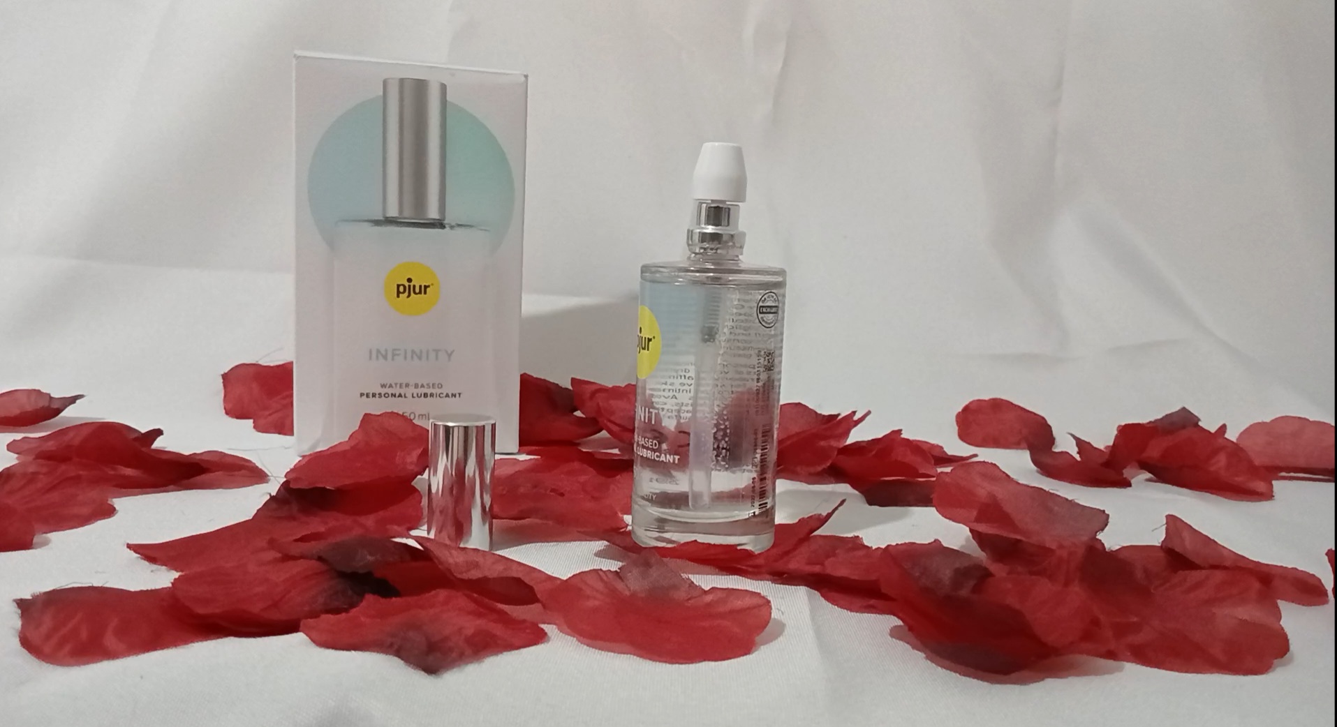Pjur Infinity water based lubricant on red rose petals