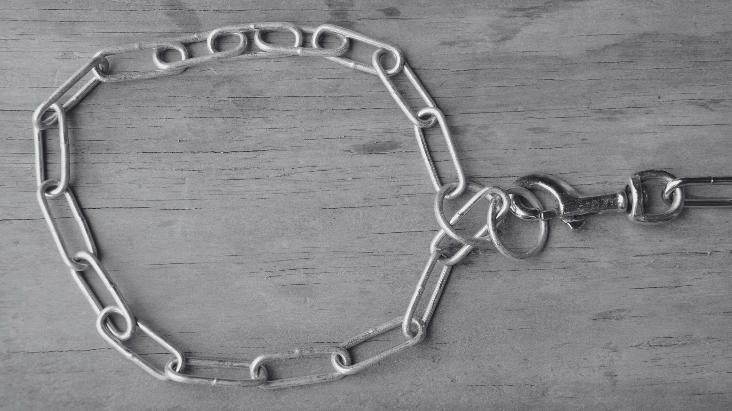 grayscale image of a choke chain, suggests choking kink
